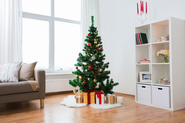 artificial christmas tree and presents at home