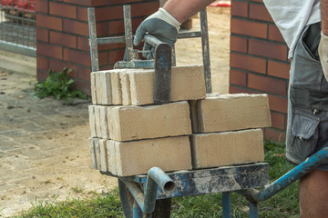 Wheelbarrow construction with bricks,  Gripping pliers for bricks
