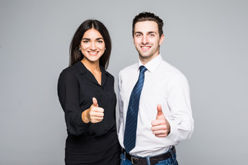 A portrait of a businesswoman and a businessman standing and showing ok isolated on grey