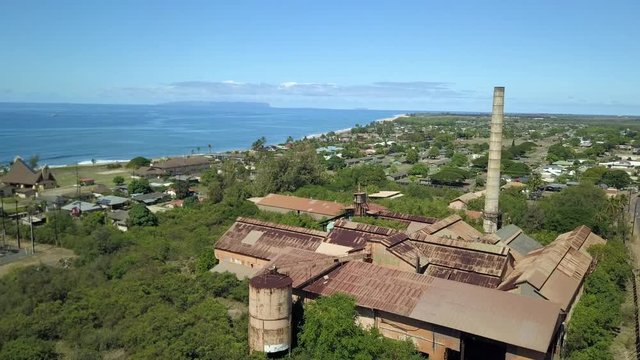 Aerial Kekaha Waimea Kauai Hawaii old sugar mill descent. Old abandoned and derelict 1800's. Rusty building and equipment. Kauai is the oldest Hawaiian Island. Garden Isle. Economy is tourism based.