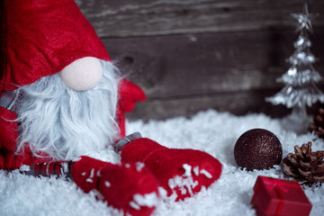 Christmas dwarf on snow with Christmas decorative.