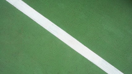 white line on green tennis court - closeup