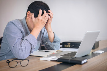 Image of Frustrated stressed business man and graph business with computer laptop in the workplace