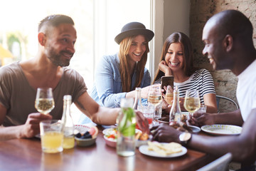 Friends reunion in restaurant and sharing news