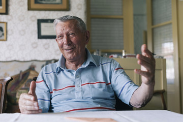 Elderly man sitting at the table