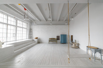 Interior with vintage furniture, light studio with old bench and blue case. Spacious studio with a...
