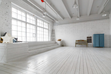 Interior with vintage furniture, light studio with old bench and blue case. Spacious studio with a high ceiling and a big window for photo shooting. Natural light