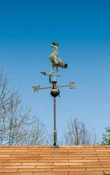 Rooster Weathervane On A Roof