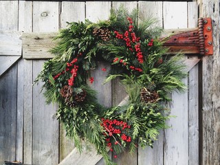 Happy Holiday Merry Christmas wreath with greens and berries