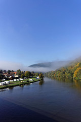 foggy river landscape and forest in autumn colors