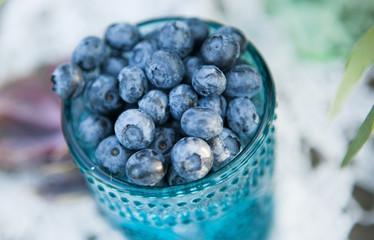Useful blueberry berry in a vintage cup
