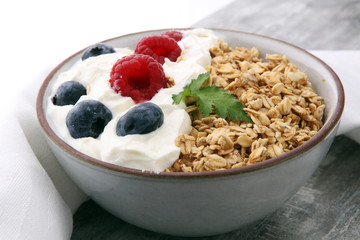 Bowl of homemade granola with yogurt and fresh berries