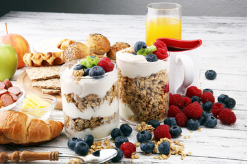 Breakfast served with coffee, orange juice, bread, parfaits and fruits. Balanced diet