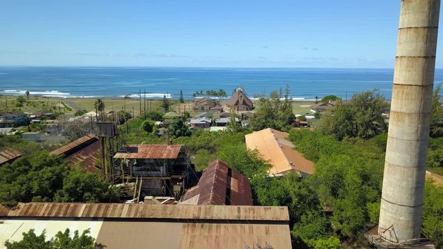 Aerial Kekaha Waimea Kauai Hawaii old sugar mill ocean part 2. Old abandoned and derelict Sugar Mill. Rusty building and equipment. Garden Isle. Economy is now tourism based.