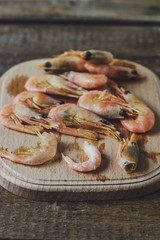 shrimp - a handful of seafood on a wooden background