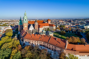 Royal Wawel Gothic Cathedral in Cracow, Poland, part of Wawel Castle, yard, park and tourists. Aerial view at sunset in fall