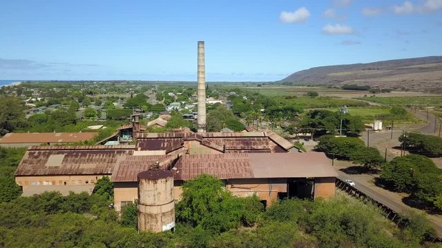 Aerial Kekaha Waimea Kauai Hawaii old sugar mill towards. Old abandoned and derelict Sugar Mill of Koloa built 1835. Rusty building and equipment. Kauai is the oldest Hawaiian Island.