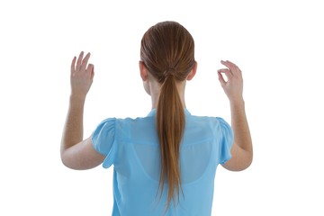 Rear view of businesswoman touching imaginary interface