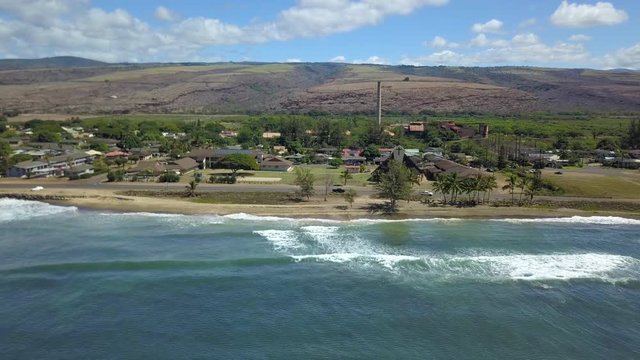 Aerial Kekaha Waimea Kauai Hawaii ocean beach town. Old abandoned sugar mill. Surfing and swimming prime recreation. Garden Isle. Economy is tourism based. Tourist enjoy beach and warm climate.