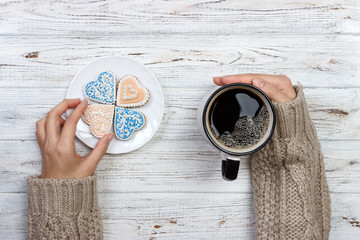 People Hands Showing Heart Shape Cookies with Coffee Cup