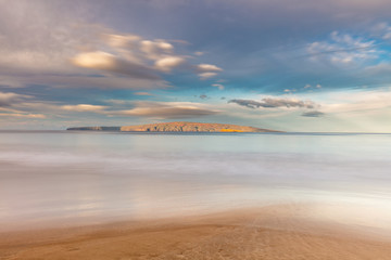 Long exposure of Hawaiian Islands Kaho'olawe and Molokini Glowing at Sunrise from the shores of...
