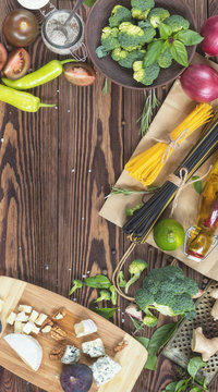 Fresh organic vegetables and kitchen items on wooden background. Top view. Copy space