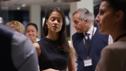  Diverse business group talking and networking at a business conference