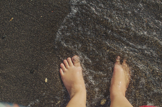 Waves hitting feet at beach