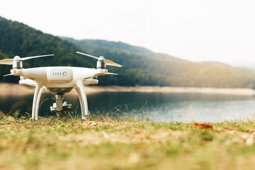 White drone on the meadow near Lake Vidraru at Fagaras Mountains. Romania