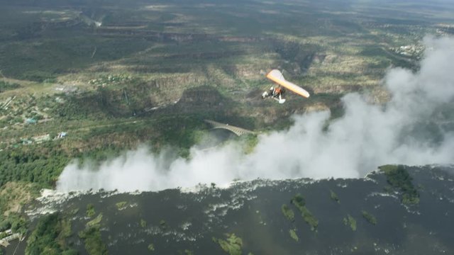 Aerial view of microlight aircraft flying above Victoria Falls & Zambezi river