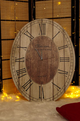 White and gold christmas interior decoration with yellow lights and candles and watch