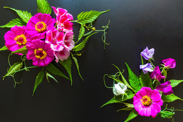 Festive flower composition on the black background. Overhead view.