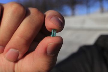 emeralds and gemstone in the hand