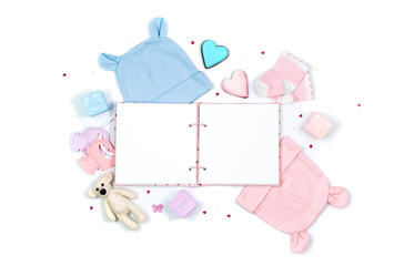 Baby accessories and open empty book isolated on white background