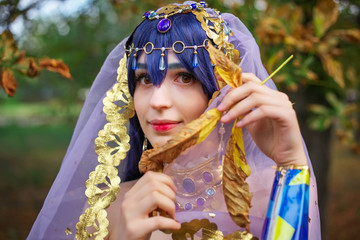 Beautiful girl in original suit, cosplay character in autumn park. Anime festival