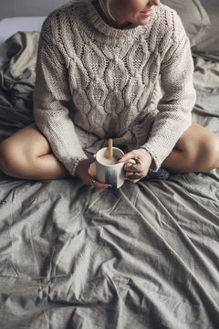 Woman Drinking Hot Coffee in Bed in the Morning