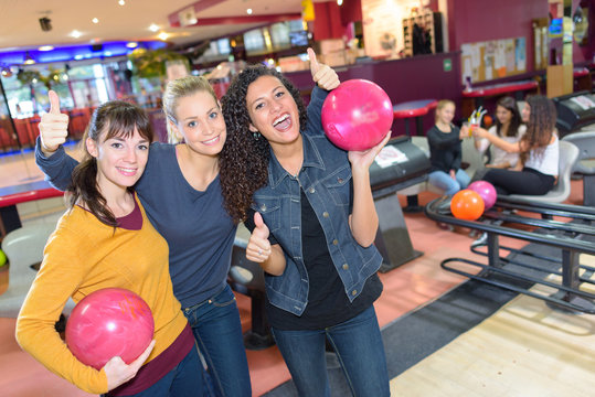 Portrait of three women at bowling alley