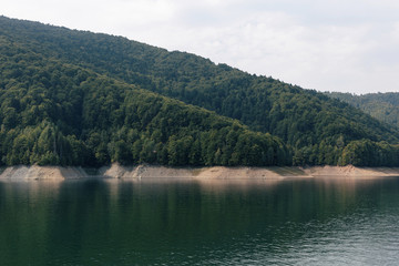 Fototapeta na wymiar Lake Vidraru at Fagaras Mountains. Romania