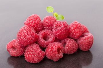 Raspberry berries with a green leaf.