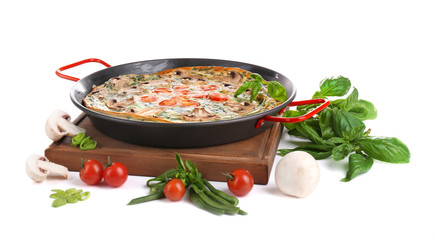 Spinach frittata in pan and vegetables, isolated on white