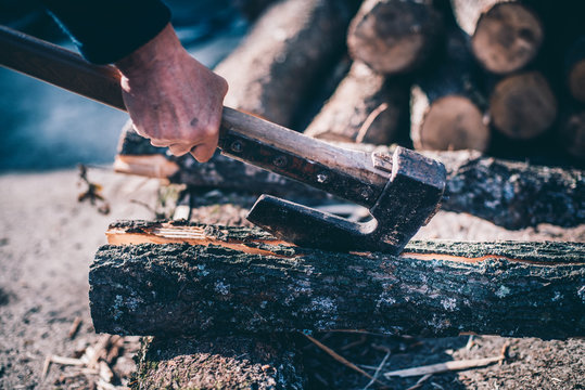 Man cutting wood with axe