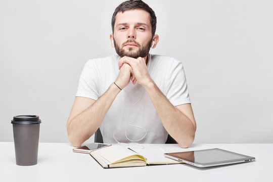 People, Business, Occupation Concept. Sad And Tired Caucasian Male Manager Can't Focus On His Duties, Thinking About Problems In His Relationships, As Sits At Work Place, Feeling Lonely And Upset.