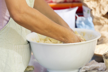 Hands of a woman kneading flour to make sweets