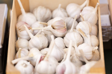 Garlic in a wooden bowl to sell at a flea market.
