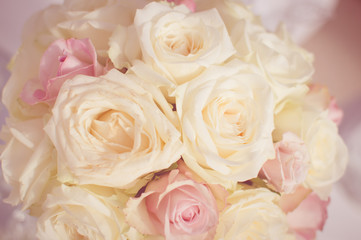 Close up on wedding flowers, bridal bouquet. Decoration made of roses over light celebration background