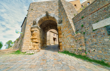 stone arch in street of Volterra