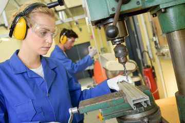 Woman using bench drill