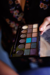 makeup artist holding palette