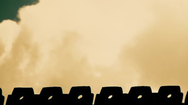 Dusk orange sky with a black silhouette crow flying away