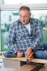 male carpenter use measuring tape measure wood